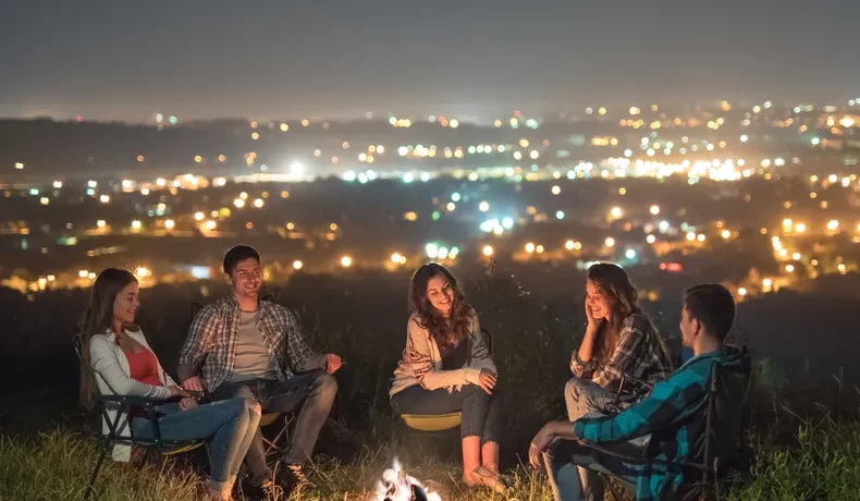 people relax near bonfire